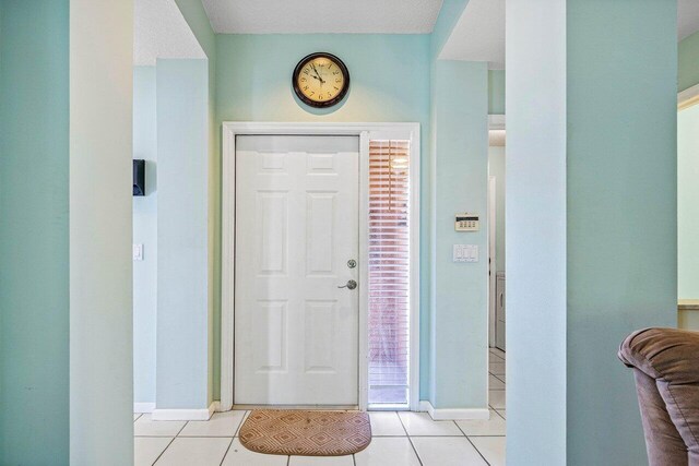 tiled foyer with a textured ceiling