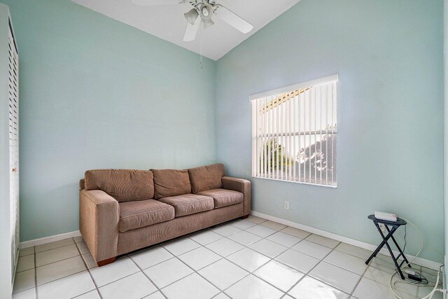 living room featuring vaulted ceiling, ceiling fan, and light tile patterned flooring