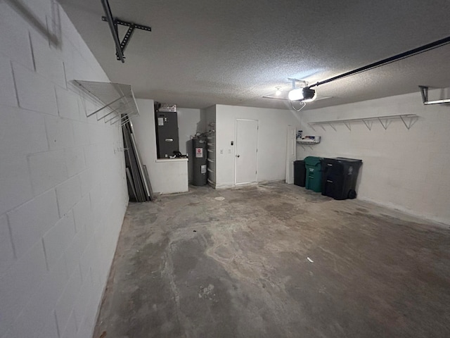 garage featuring heating unit, electric water heater, and a garage door opener