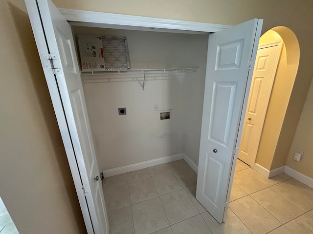 clothes washing area with hookup for a washing machine, light tile patterned floors, and electric dryer hookup