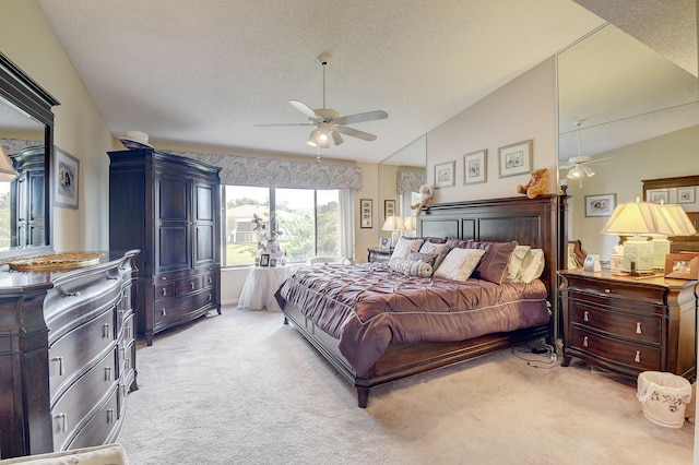 bedroom featuring a textured ceiling, ceiling fan, light carpet, and vaulted ceiling