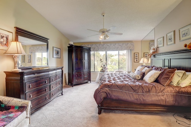 carpeted bedroom with a textured ceiling, ceiling fan, and lofted ceiling