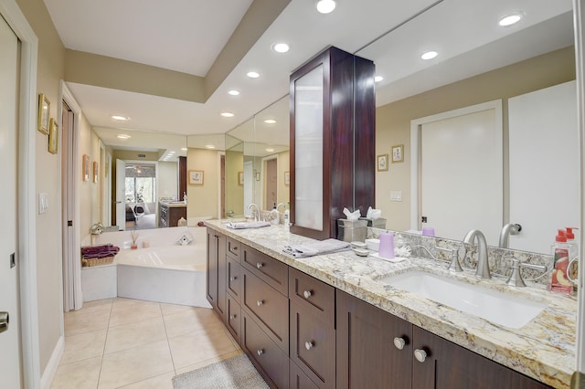 bathroom with tile patterned flooring, vanity, and a bathing tub