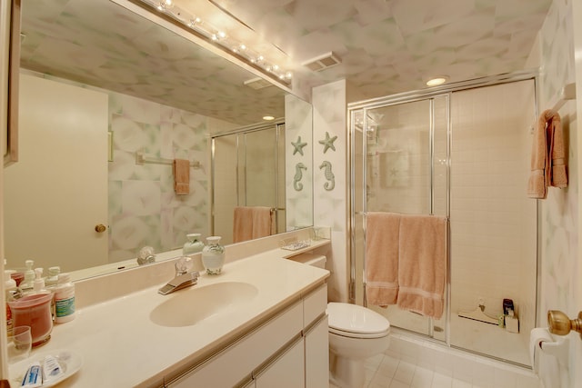 bathroom featuring toilet, tile patterned flooring, vanity, and walk in shower