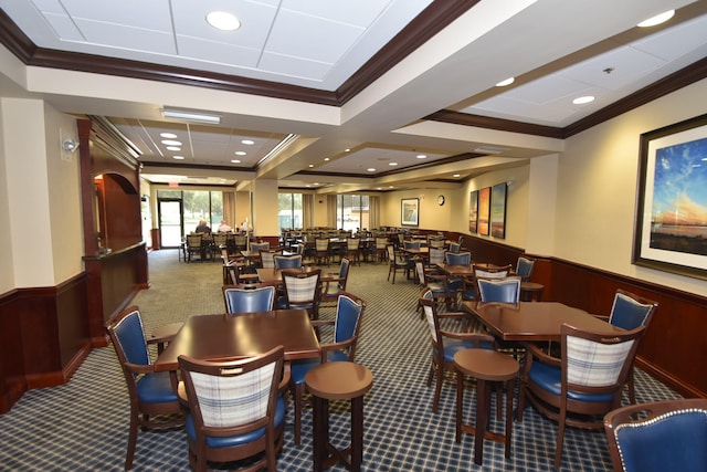 dining area featuring carpet flooring, ornamental molding, and coffered ceiling