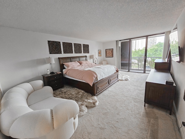 carpeted bedroom featuring a textured ceiling and access to outside