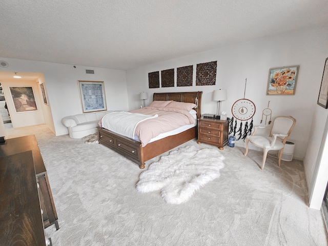 carpeted bedroom with a textured ceiling