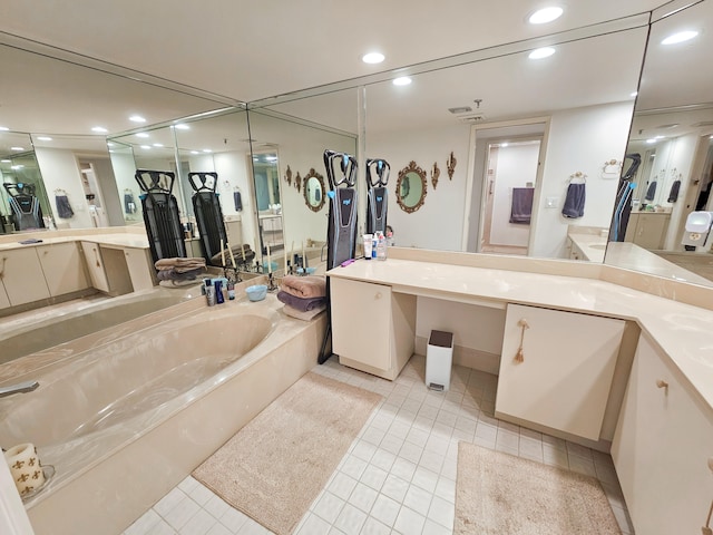 bathroom featuring tile patterned flooring, vanity, and a bathing tub