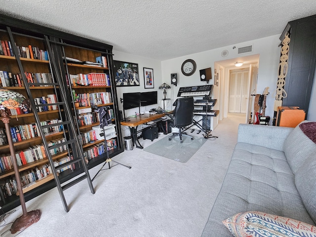 carpeted office featuring a textured ceiling