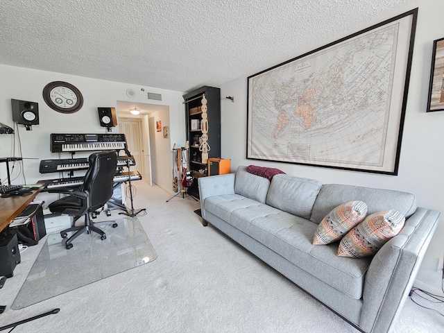 carpeted home office featuring a textured ceiling