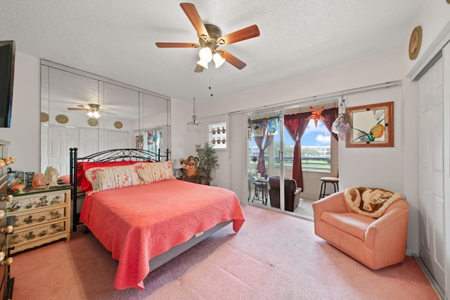 bedroom featuring carpet flooring, ceiling fan, and a textured ceiling