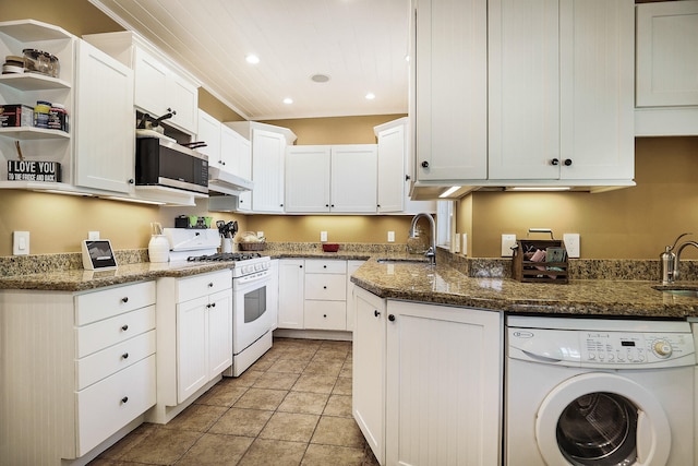 kitchen with dark stone counters, sink, washer / clothes dryer, white cabinetry, and white gas stove