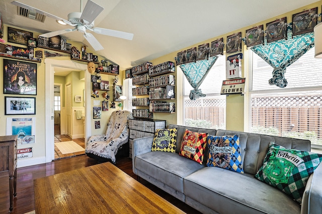 living room featuring dark hardwood / wood-style floors, ceiling fan, and lofted ceiling