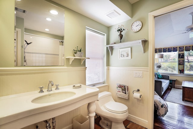 bathroom featuring hardwood / wood-style floors, curtained shower, a healthy amount of sunlight, and sink