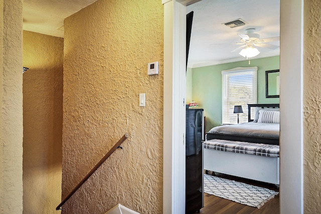 bedroom with wood-type flooring, ceiling fan, and ornamental molding