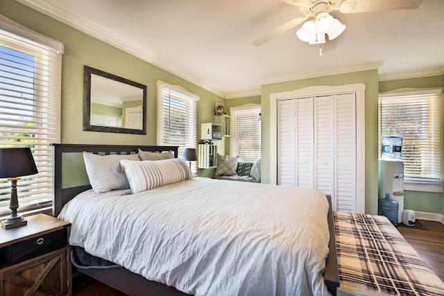 bedroom featuring ceiling fan, a closet, dark wood-type flooring, and ornamental molding