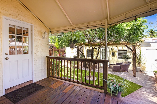 wooden terrace with a gazebo and an outdoor hangout area