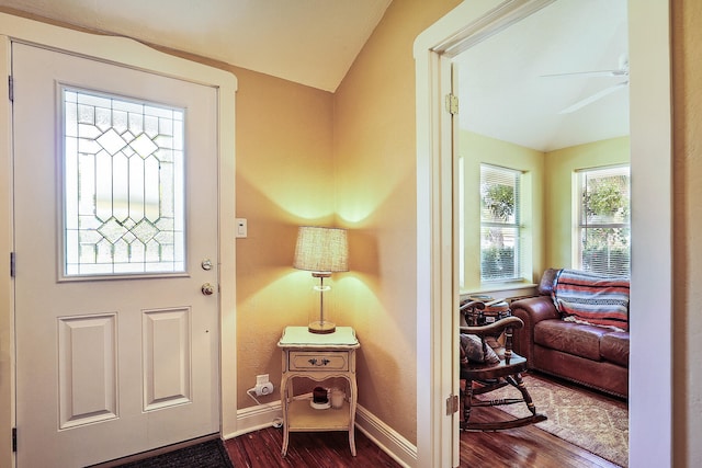 entrance foyer with lofted ceiling, ceiling fan, and dark hardwood / wood-style floors