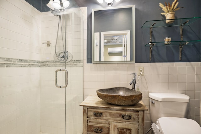 bathroom with vanity, toilet, an enclosed shower, and tile walls