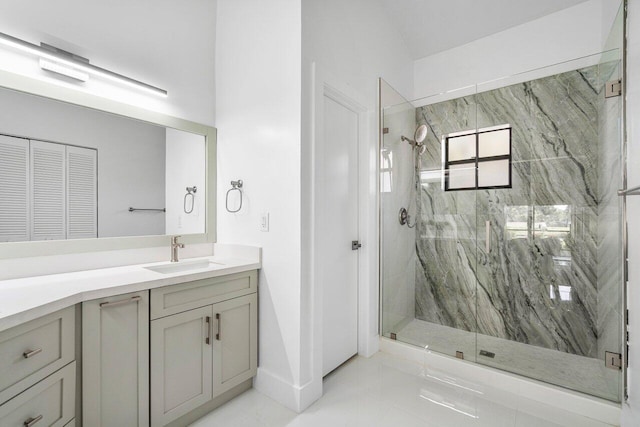 bathroom featuring tile patterned flooring, vanity, and a shower with shower door