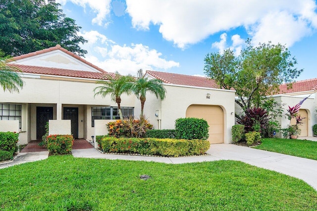 mediterranean / spanish-style house with a garage and a front lawn