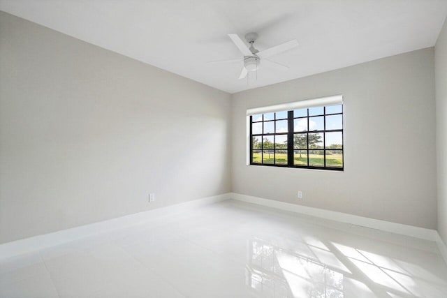 empty room with light tile patterned floors and ceiling fan