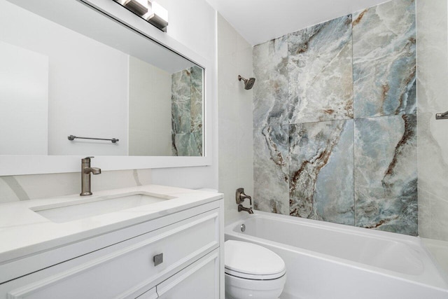 full bathroom featuring vanity, tiled shower / bath combo, and toilet