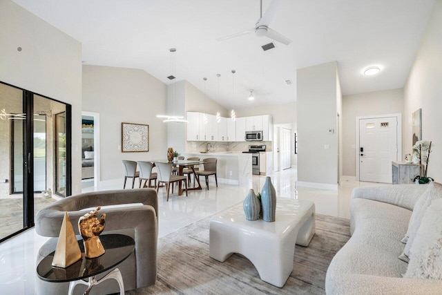 living room featuring ceiling fan and high vaulted ceiling