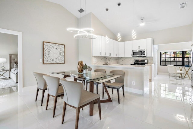 tiled dining room with high vaulted ceiling