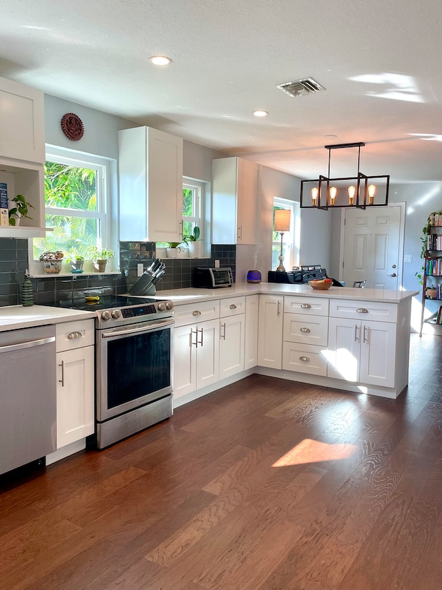 kitchen with white cabinets and hanging light fixtures