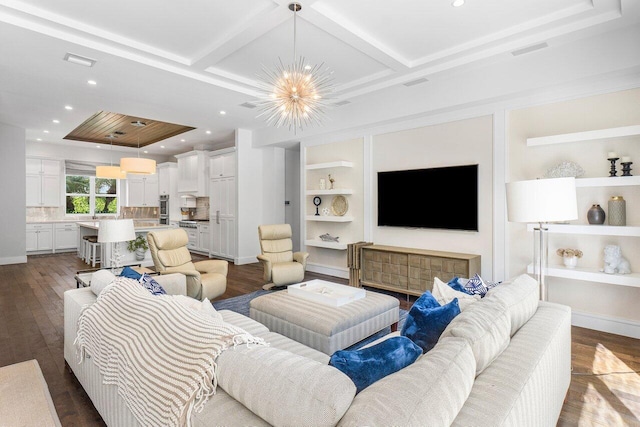 living room featuring a notable chandelier, built in shelves, dark wood-type flooring, and coffered ceiling