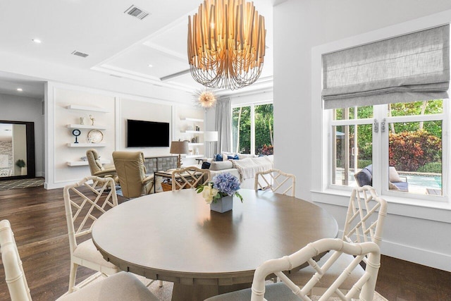 dining space with dark hardwood / wood-style flooring, plenty of natural light, built in shelves, and a notable chandelier