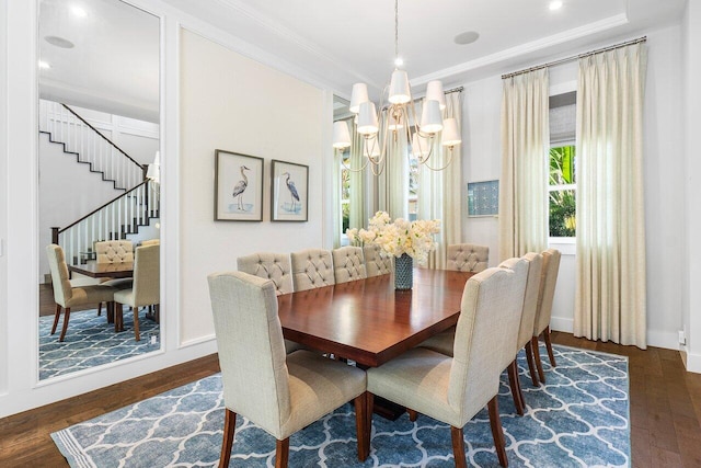 dining area featuring crown molding, dark wood-type flooring, and a notable chandelier