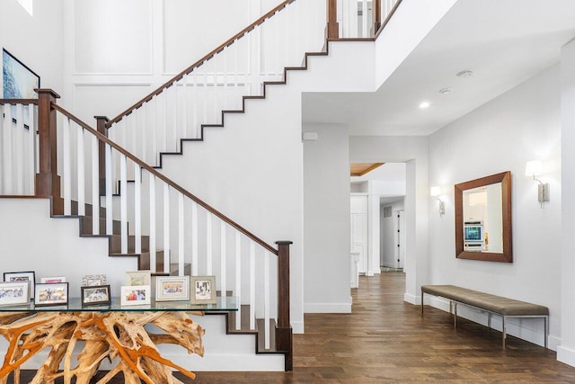 staircase with hardwood / wood-style floors