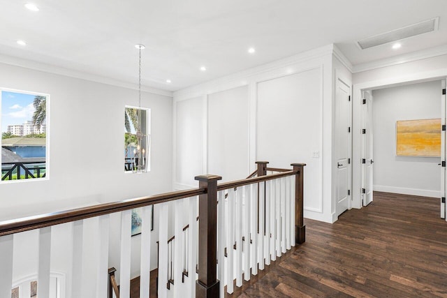 hallway featuring dark hardwood / wood-style flooring and crown molding