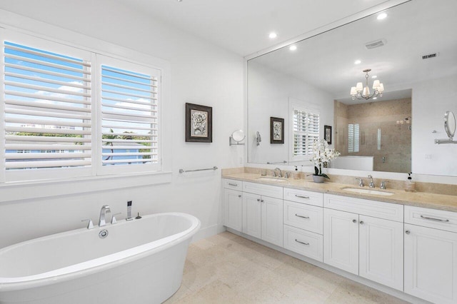 bathroom featuring a chandelier, vanity, and independent shower and bath