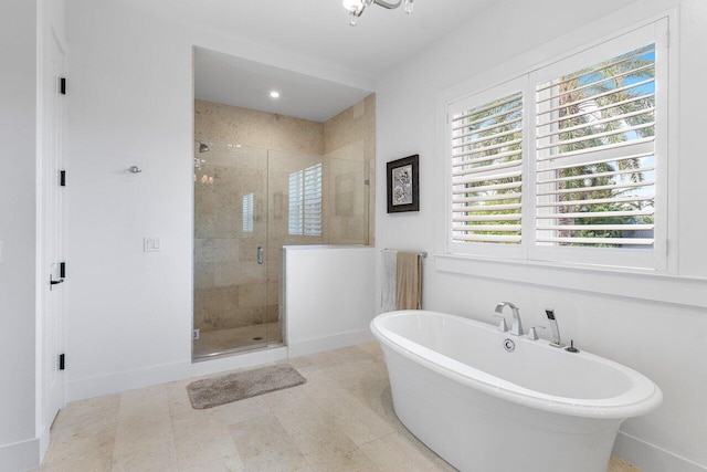 bathroom featuring independent shower and bath