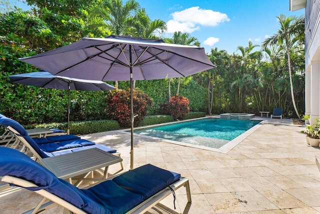 view of pool featuring an in ground hot tub and a patio