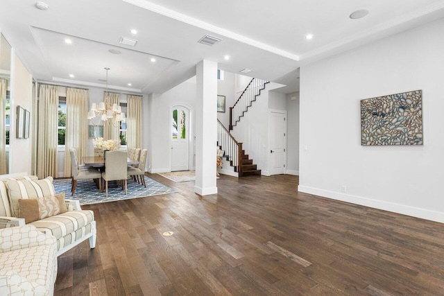 dining area with dark hardwood / wood-style flooring and a notable chandelier