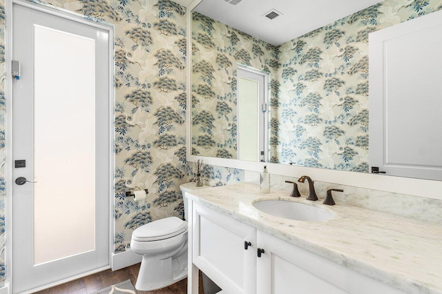 bathroom featuring hardwood / wood-style floors, vanity, and toilet