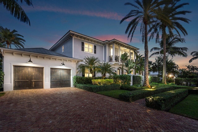 view of front of property with a garage and a balcony