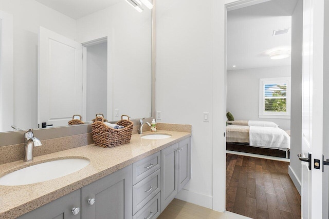 bathroom with hardwood / wood-style flooring and vanity