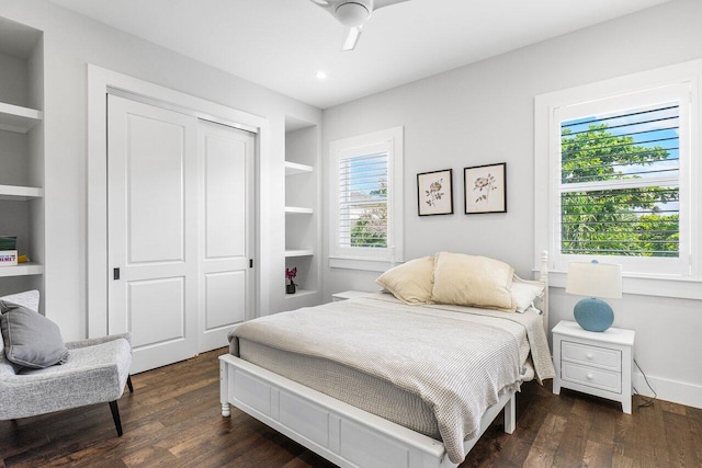 bedroom with multiple windows, ceiling fan, and dark hardwood / wood-style floors