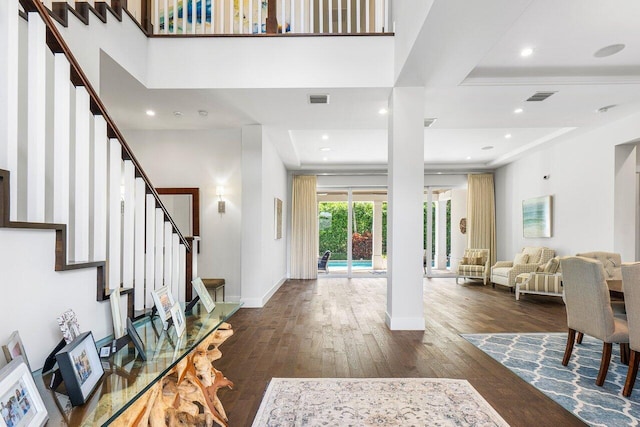 entryway featuring a raised ceiling and dark hardwood / wood-style flooring