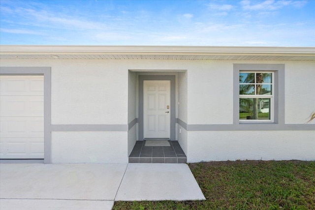 view of exterior entry with a garage