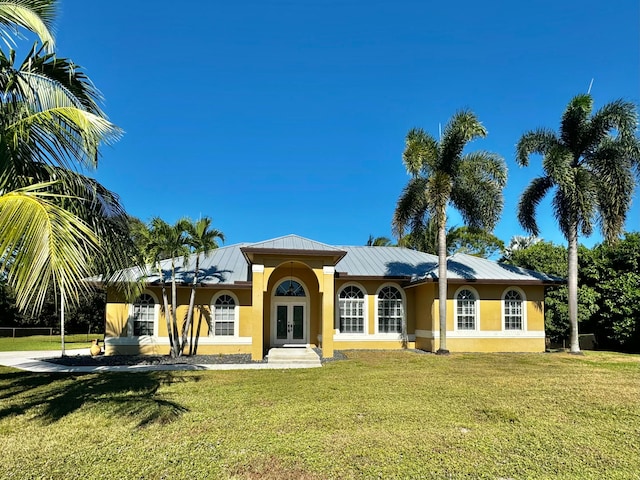 view of front facade featuring a front yard and french doors