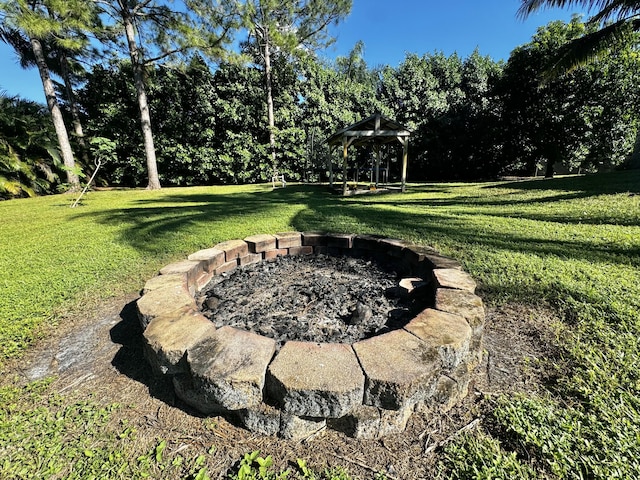 view of yard with an outdoor fire pit and a gazebo