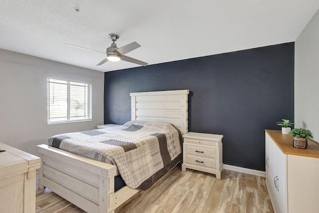 bedroom featuring ceiling fan and light hardwood / wood-style floors