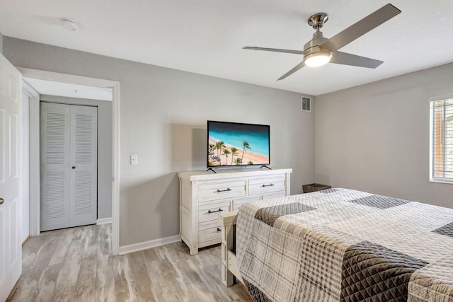 bedroom featuring ceiling fan, a closet, and light hardwood / wood-style floors