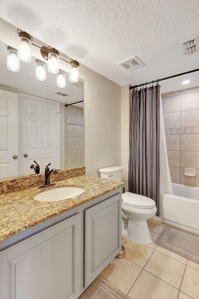 full bathroom with shower / tub combo, tile patterned floors, vanity, a textured ceiling, and toilet